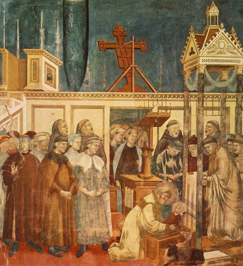 A medieval fresco of Saint Francis kneeling at a manger inside a church, with a baby on the hay, an ox and a donkey, and friars singing.